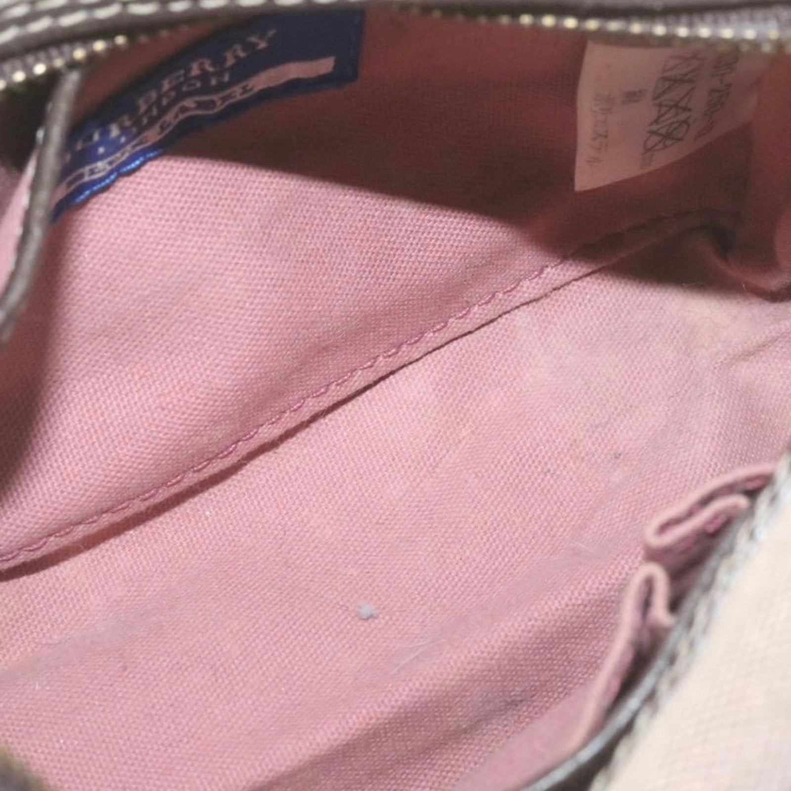 Interior of Burberry pink bag with label.