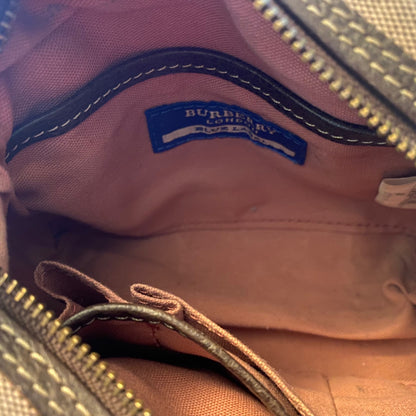 Close-up of interior of pink bag with a Burberry logo.
