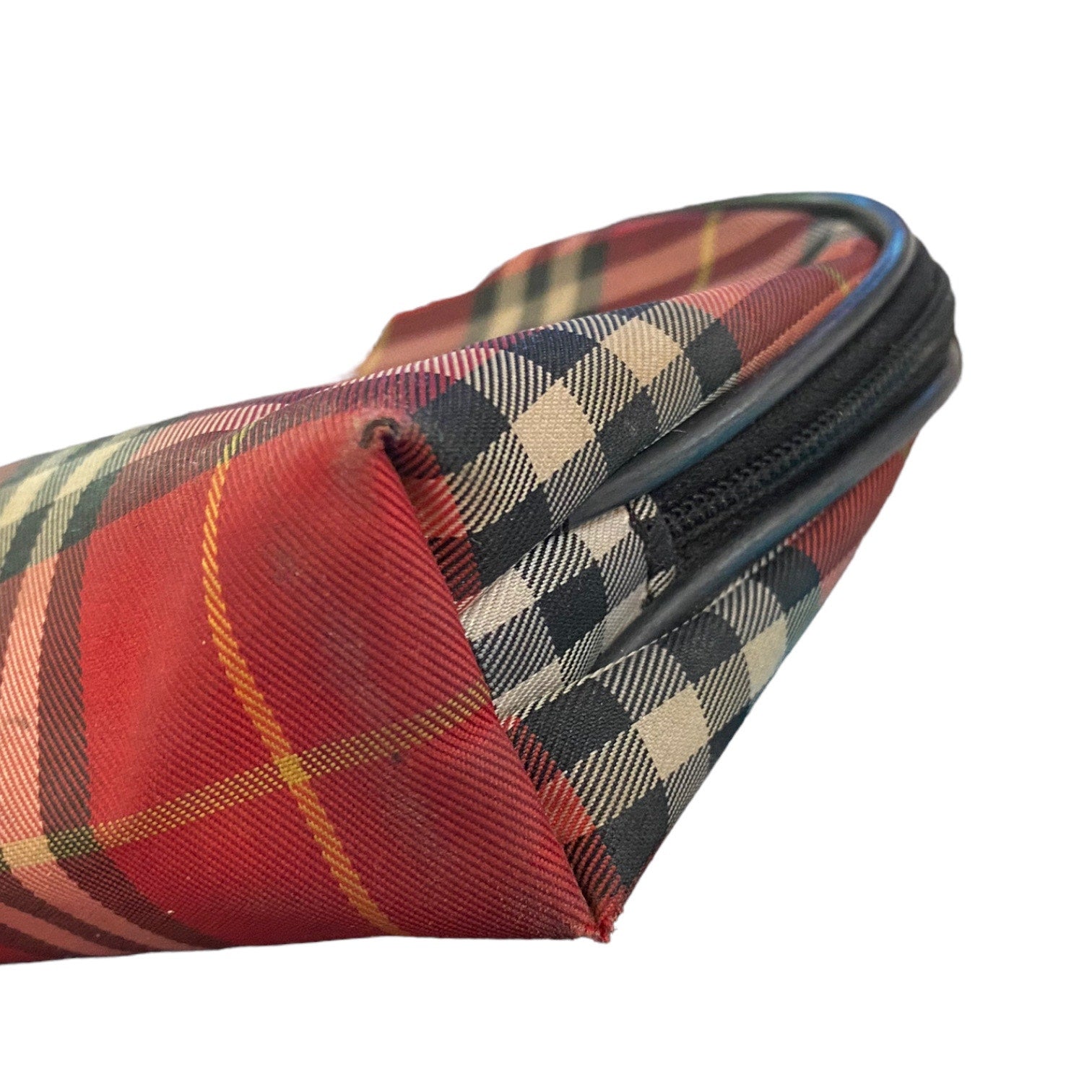 A close-up of a red tartan plaid zipper pouch with black and beige plaid lining, shown on a plain white background.