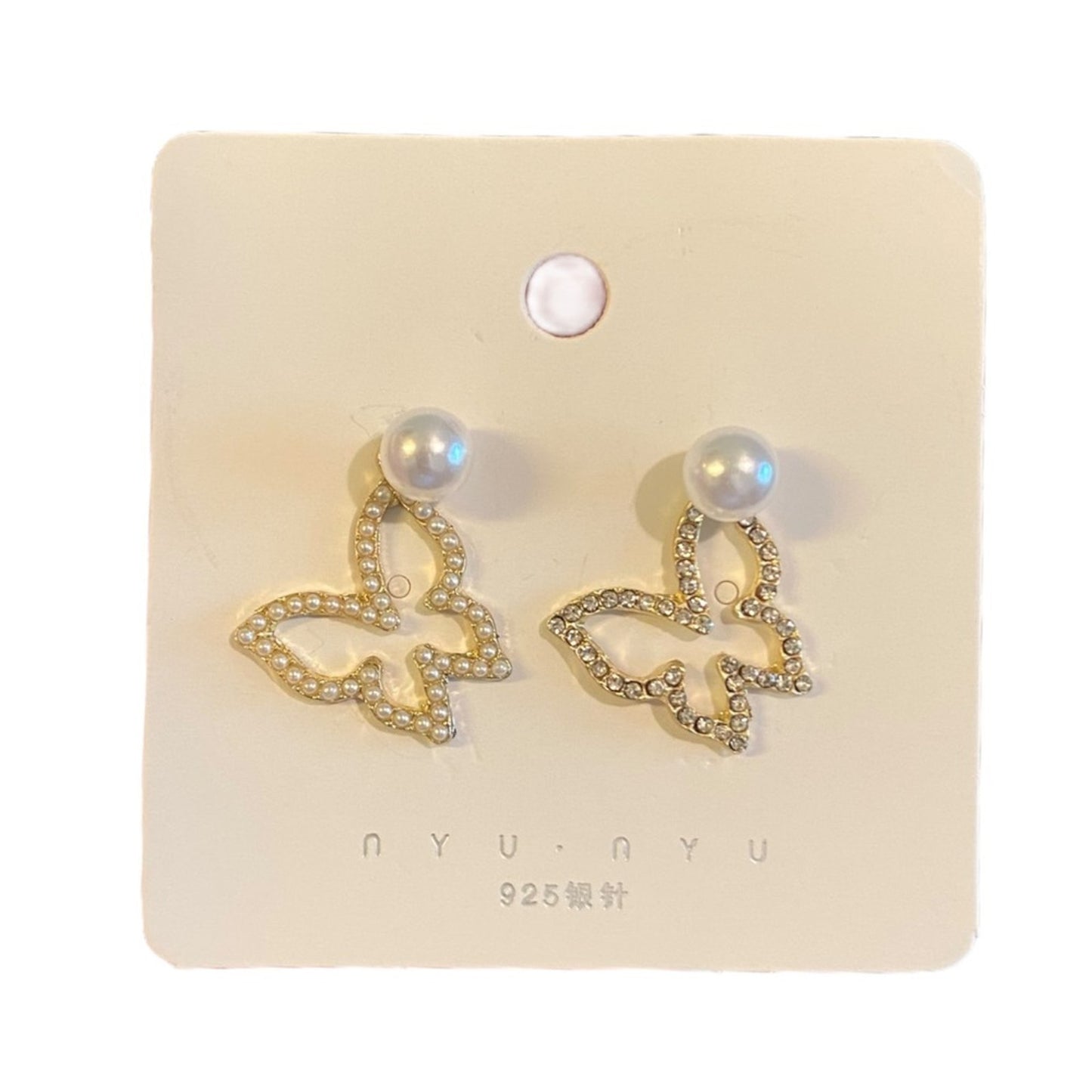 Butterfly-shaped earrings on a branded card with 'NYU NYU' branding.