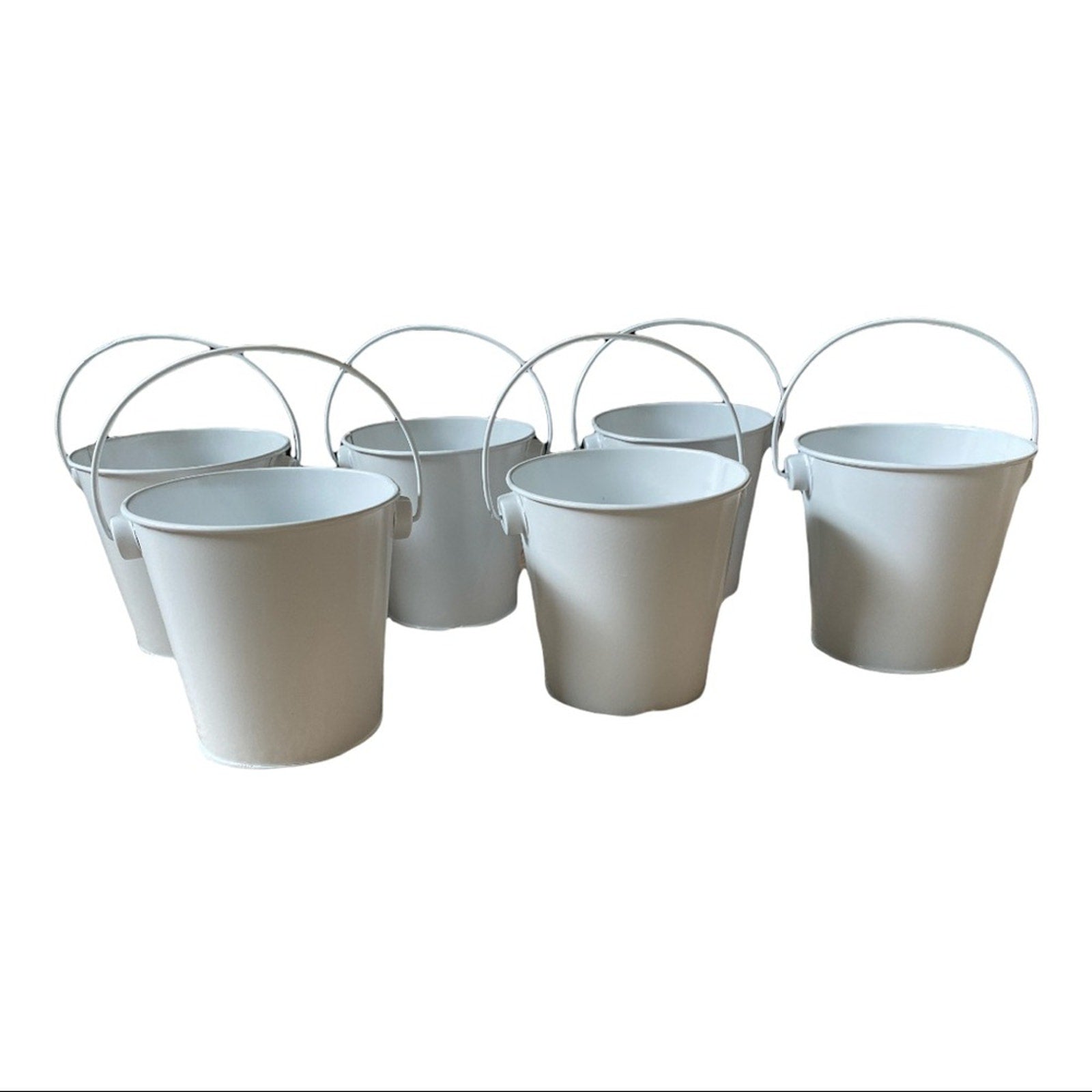 Six white metal pails with wire handles arranged together on a plain white background.