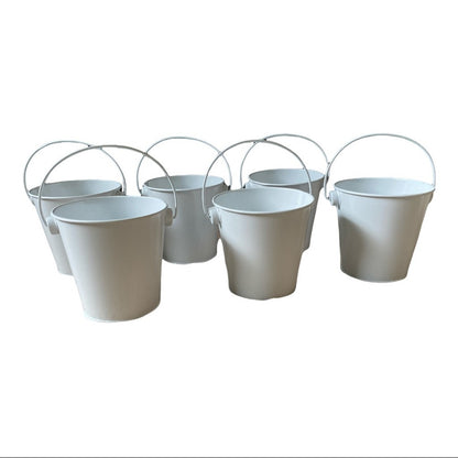 Six white metal pails with wire handles arranged together on a plain white background.