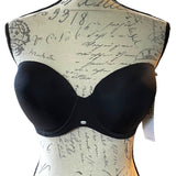 Back of Black bra on a mannequin with script patterned background