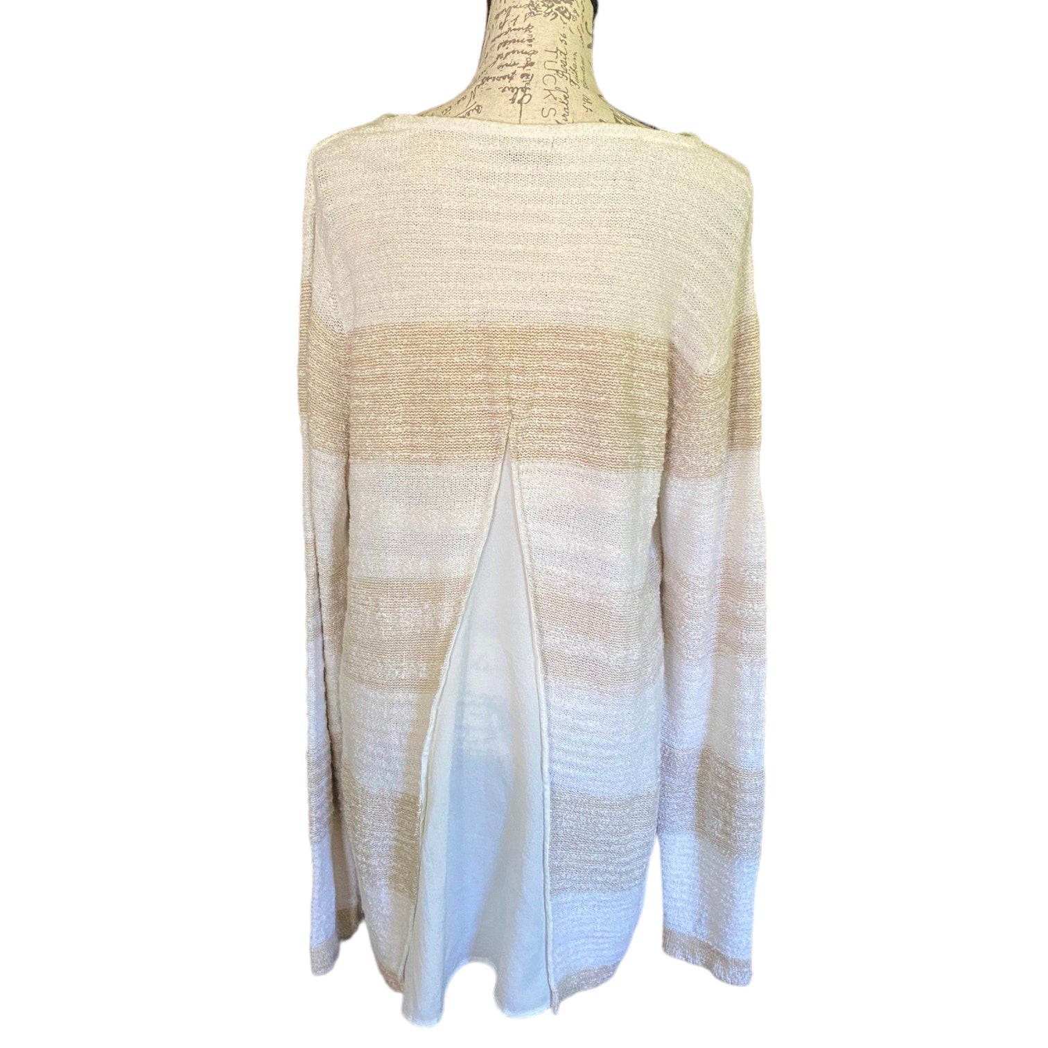 Back of Mannequin wearing a beige and white striped knit sweater on a white background