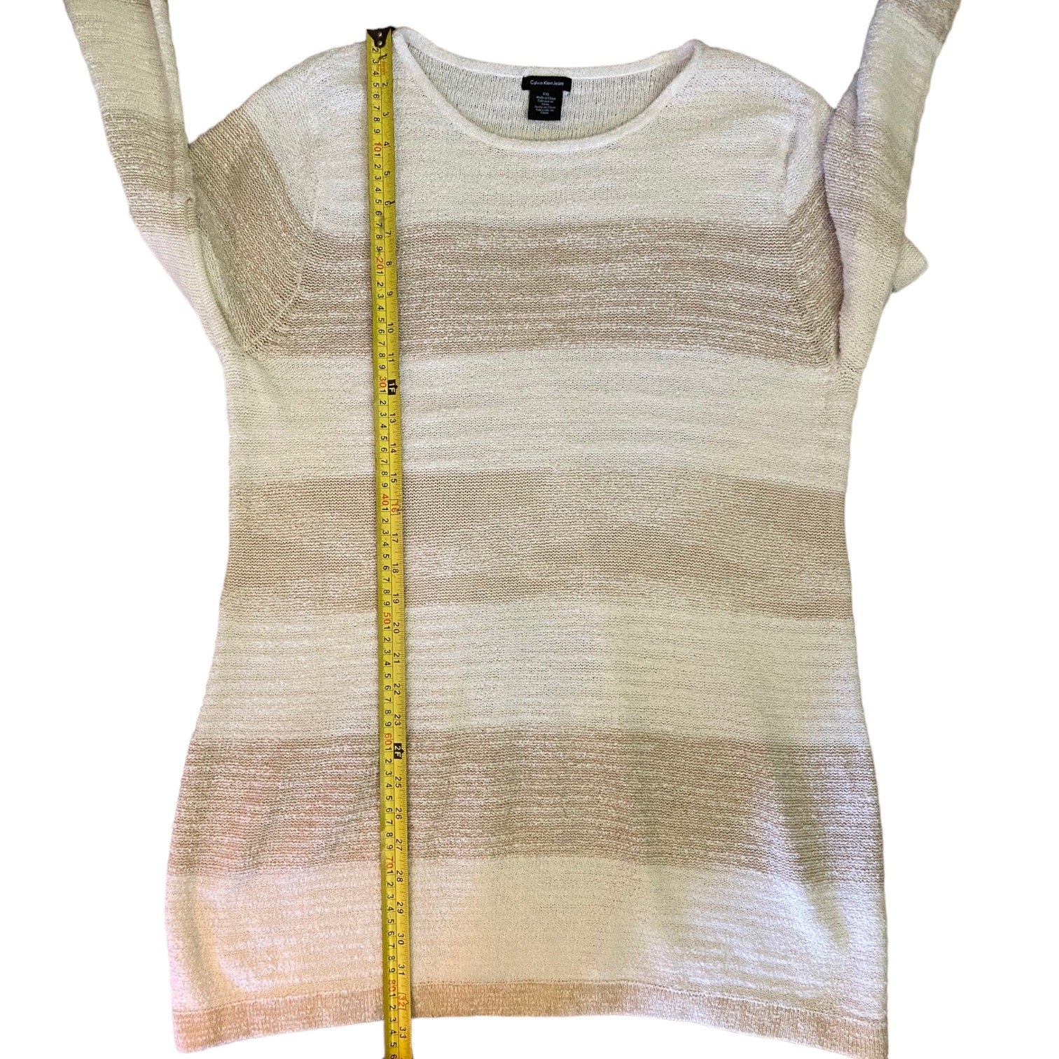 Striped sweatert with a measuring tape on a white background