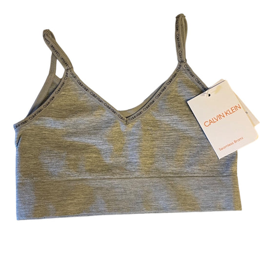 Gray sports bra with Calvin Klein tag on a white background