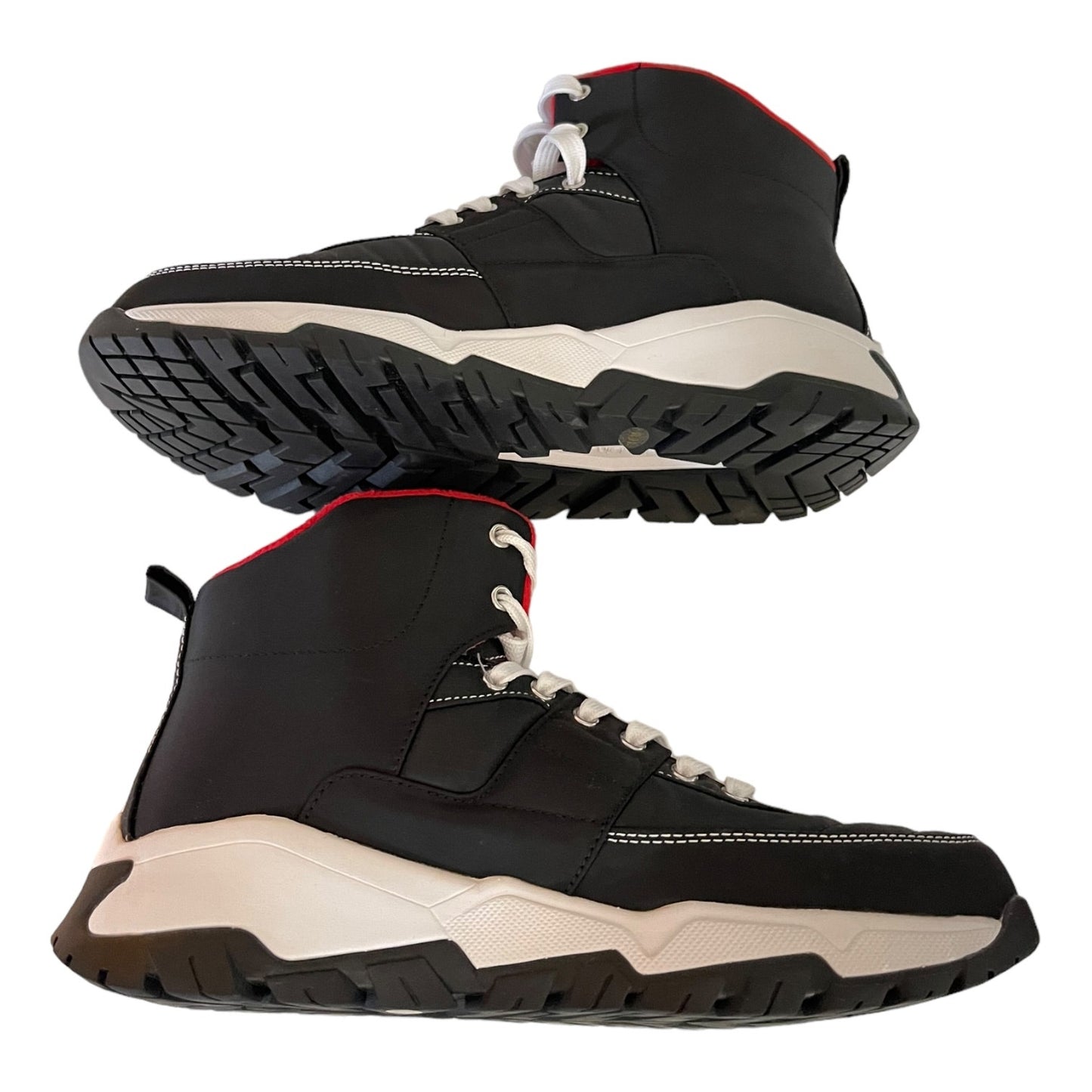 A pair of black high-top sneakers with white colored midsoles and white laces, shown from both the side and bottom angles against a plain white background.