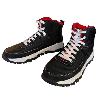 A pair of black high-top lace-up sneakers with white laces, white midsoles, and red lining details, shown on a plain white background.