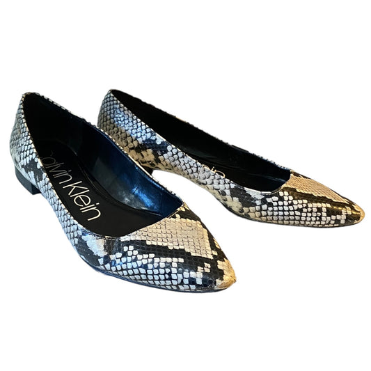 A pair of pointed-toe flat shoes by Calvin Klein, featuring a black, white, and beige python print pattern on a white background.