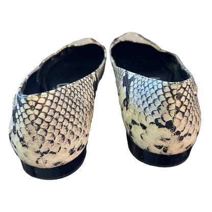 A pair of women's flat shoes featuring a snakeskin pattern in beige, black, and gray, shown from a rear three-quarter view against a plain white background.