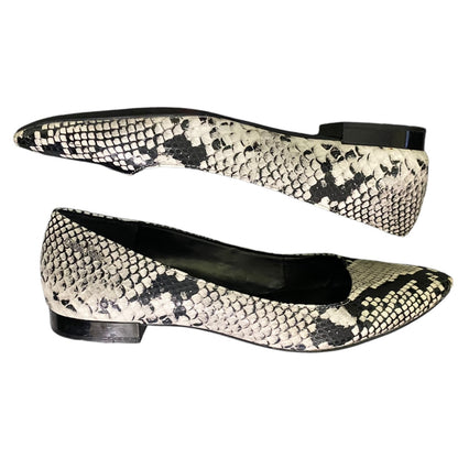 A pair of women's pointed-toe flats featuring a black and off-white python snakeskin pattern, shown against a plain white background.