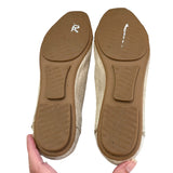 Bottom of shoes soles held by a hand on a white background