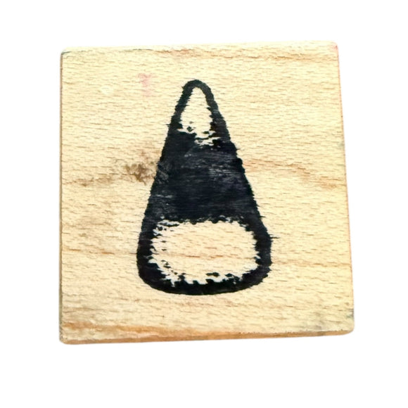 Wooden stamp with a black candy corn rubber stamp design on a white background