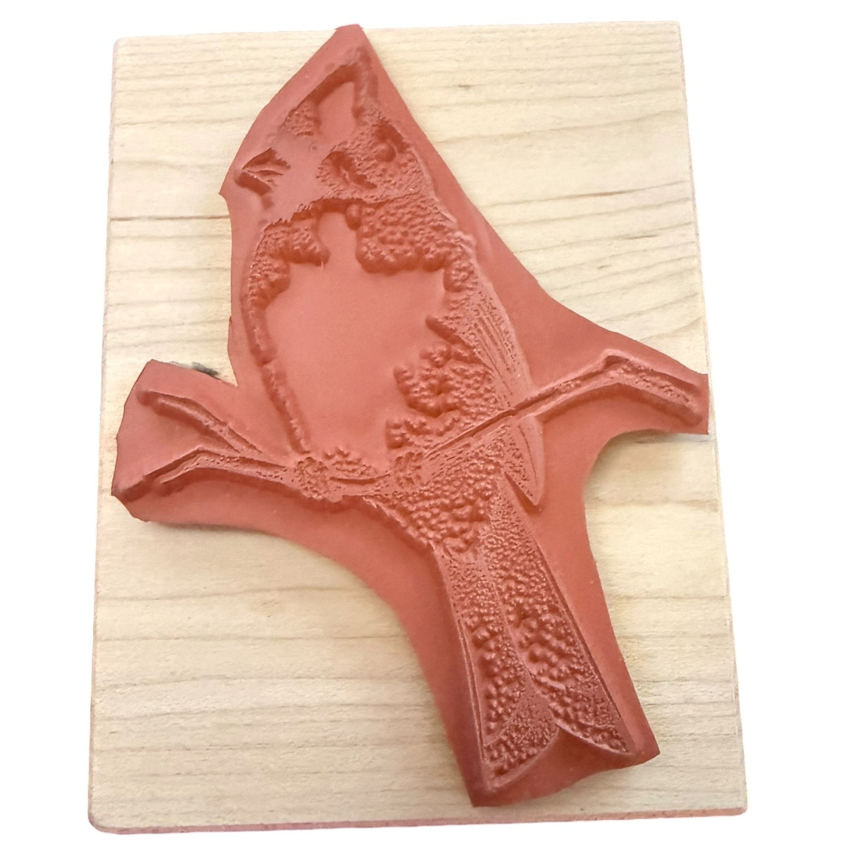 Cardinal rubber stamp on a wood block on a white background. 
