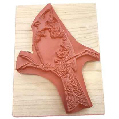 Cardinal rubber stamp on a wood block on a white background. 