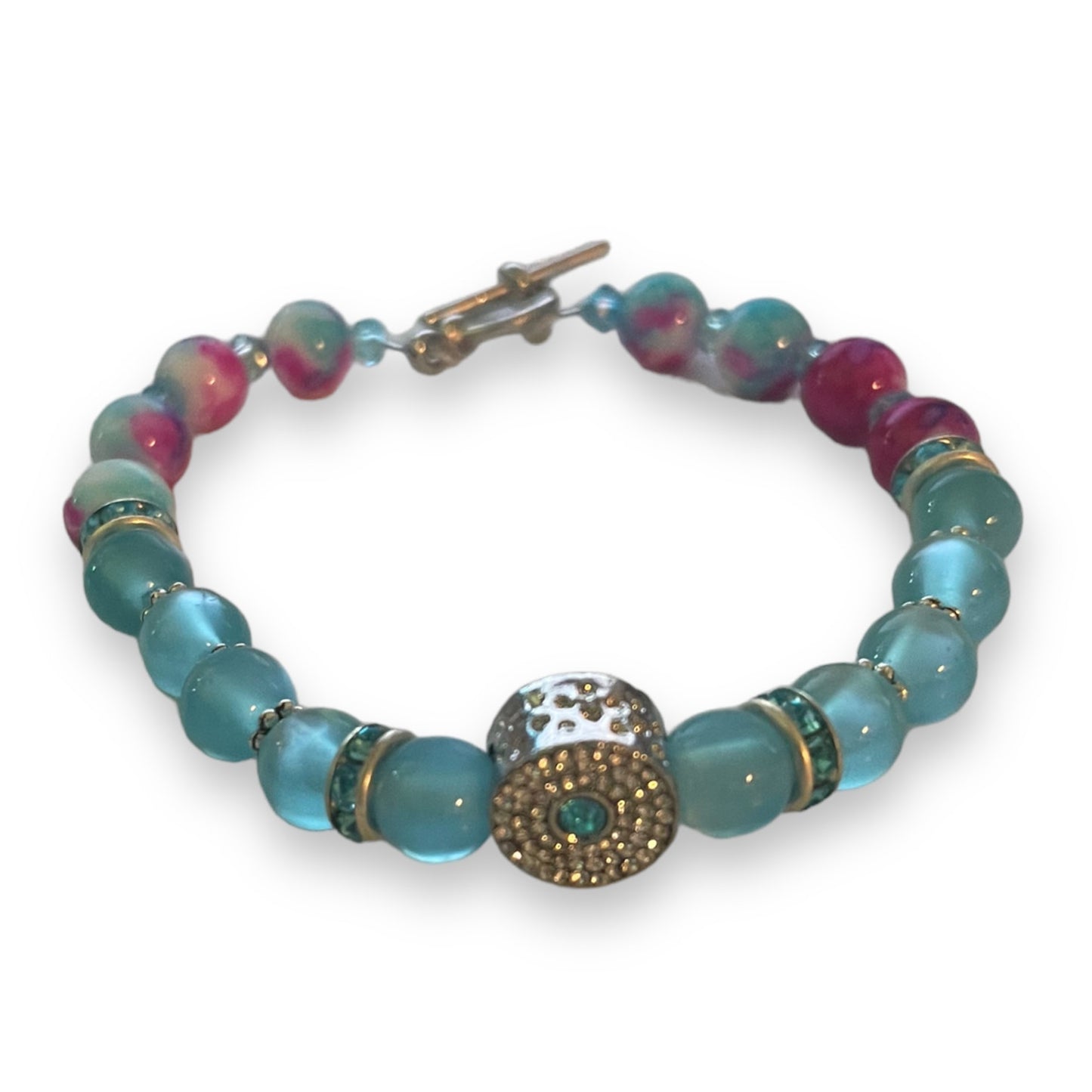 Beaded bracelet with blue and pink beads on a white background