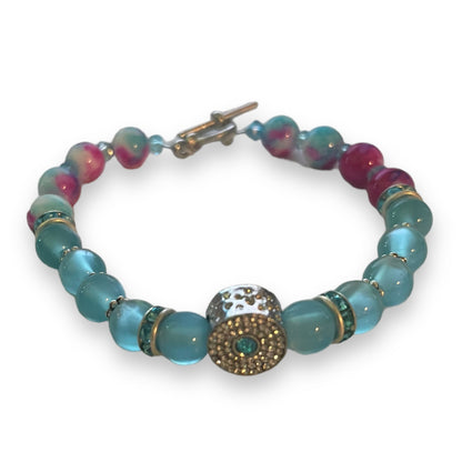 Beaded bracelet with blue and pink beads on a white background