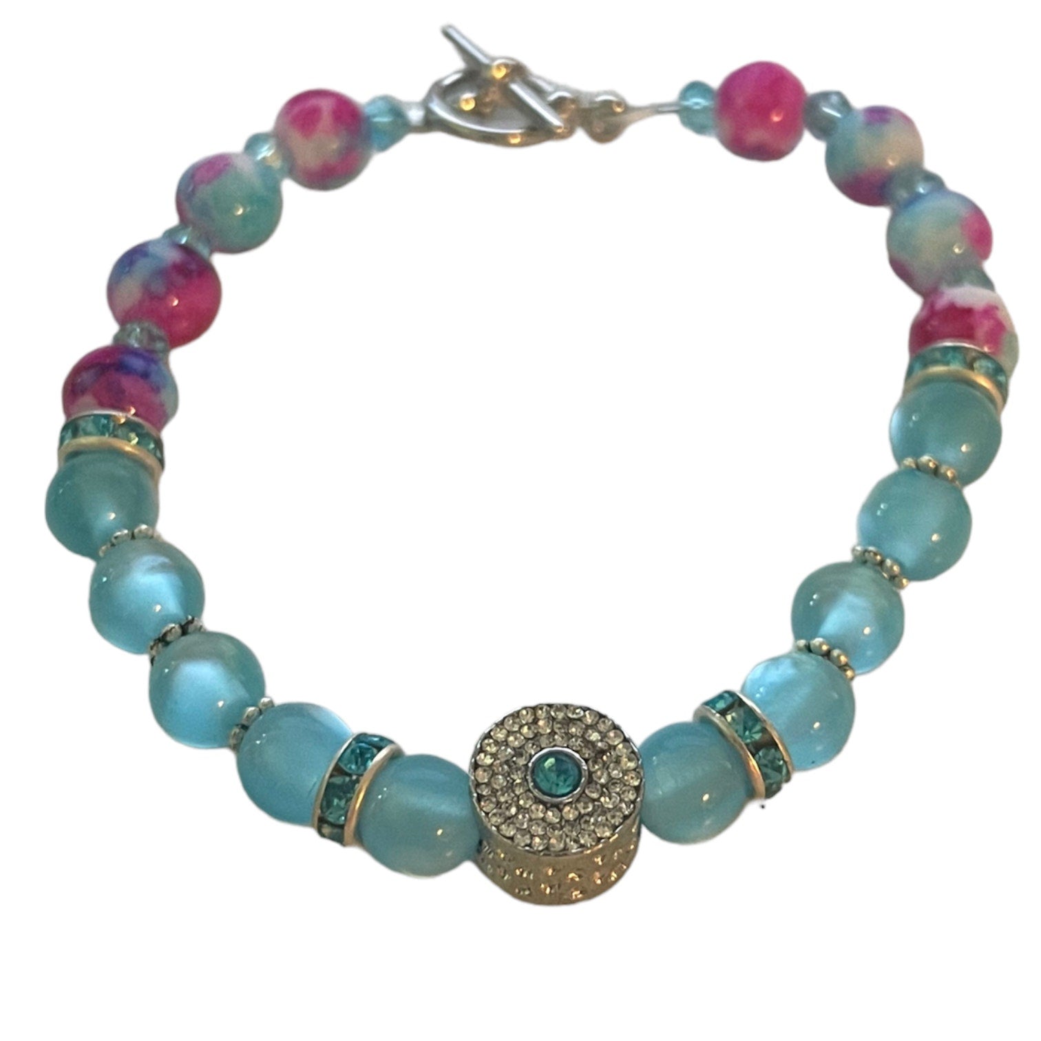 Top of Bracelet with blue and pink beads on a white background