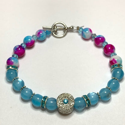 Top of Bracelet with blue and pink beads on a white background