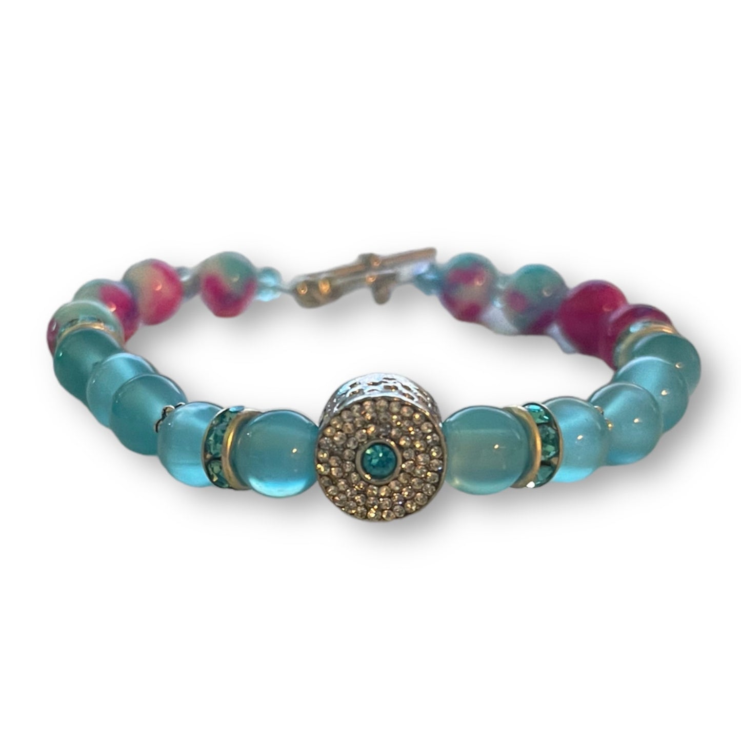 Blue pink beaded bracelet with a decorative charm on a white background