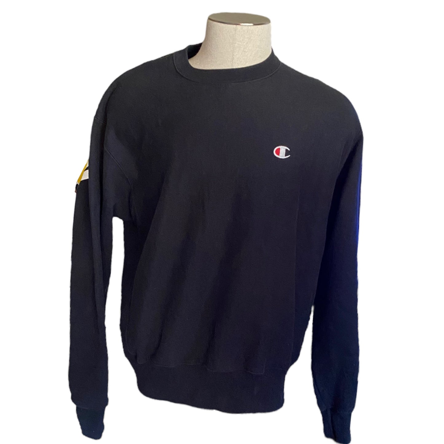 Front of Black sweatshirt with a logo on a mannequin against a white background