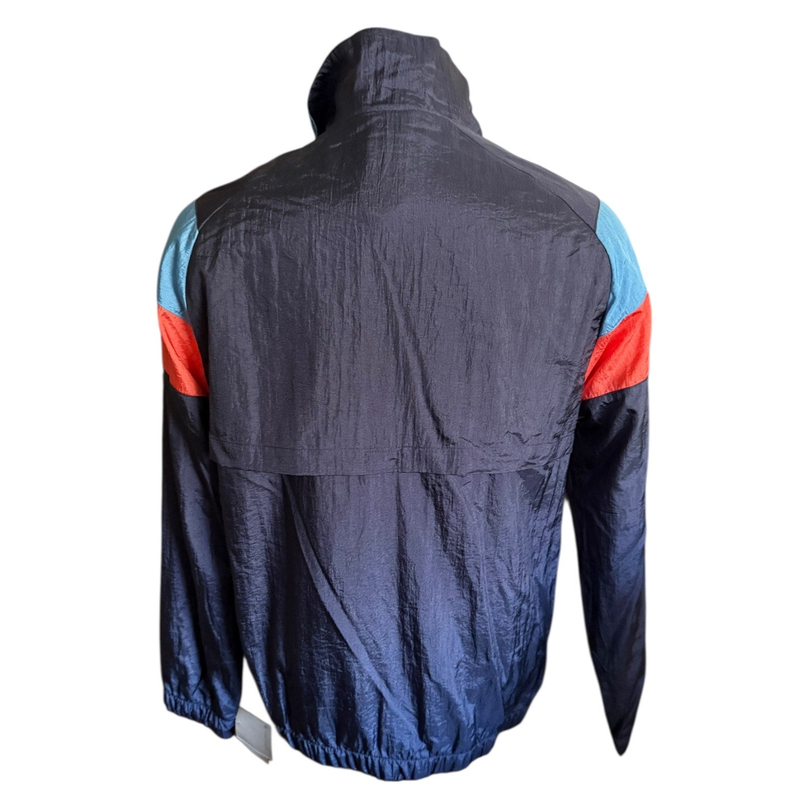 Back view of a dark blue jacket with red and blue accents on a white background