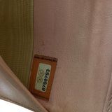 Close-up of a Chanel label on a pink fabric surface