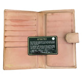 Pink leather wallet with a visible brand label on a white background