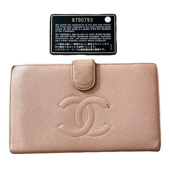 Pink wallet with Chanel logo and a certification label on a white background