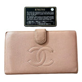Pink wallet with Chanel logo and a certification label on a white background
