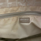 Close-up of a Chanel bag with a visible logo and 'Made in Italy' label.