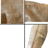 Close-up of a textured beige fabric with issues/dirt marks 