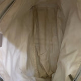 Interior Close-up of a beige fabric surface with visible texture and a zipper.