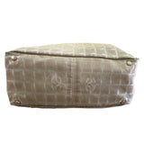 CC-patterned handbag bottom on a white background