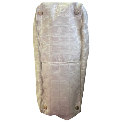 Bottom of off white beige purse with 4 metal feet and a grid CC pattern on a white background. 