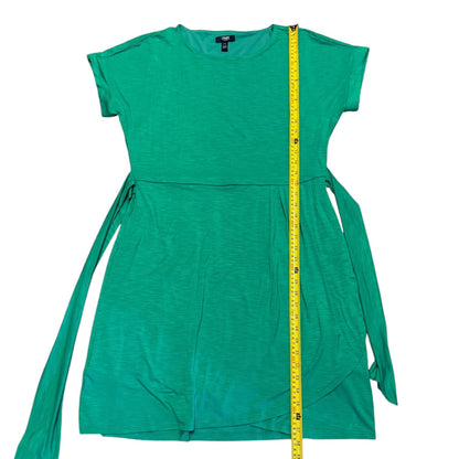 A green short-sleeve dress with side ties, shown flat on a white background with a yellow measuring tape running vertically down the center to indicate size.