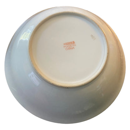 The underside of a bowl with a glossy glaze, showing a red Chinese 'MADE IN CHINA' mark on a white background.