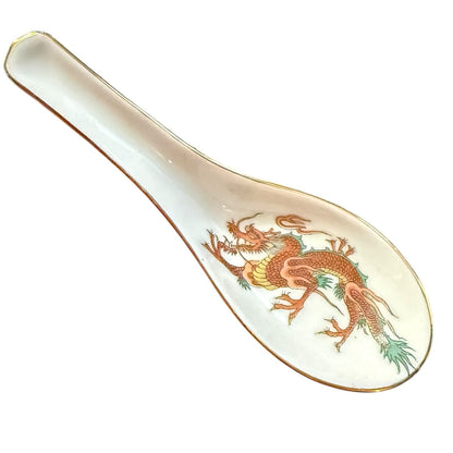 Spoon with dragon design on a white background