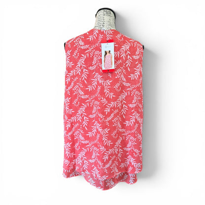 Pink shirt with white leaf pattern on a mannequin against a white background
