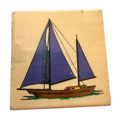 Wooden block with a sailboat design on a beige background