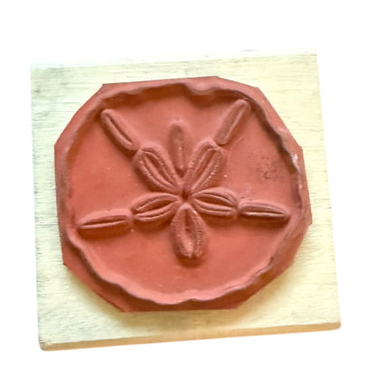 Sand dollar stamp on a wooden block
