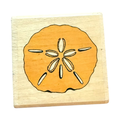 Wooden stamp with a sand dollar design on a white background