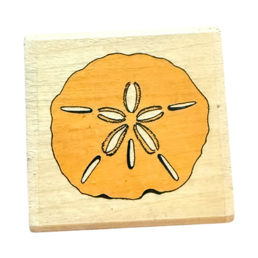 Wooden stamp with a sand dollar design on a white background
