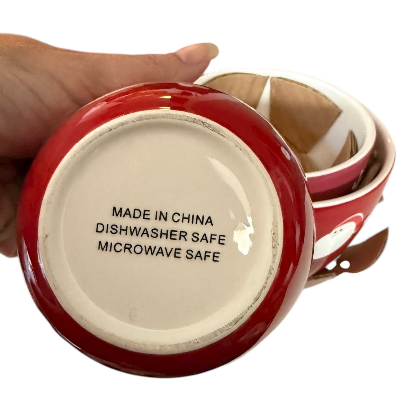 Red ceramic bowl with 'Made in China, Dishwasher Safe, Microwave Safe' text on a white background