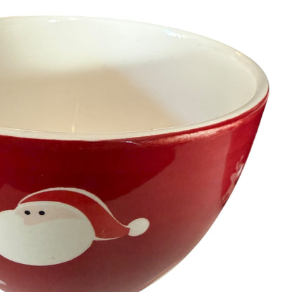 Red bowl with a white Santa hat design showing paint issue on a white background