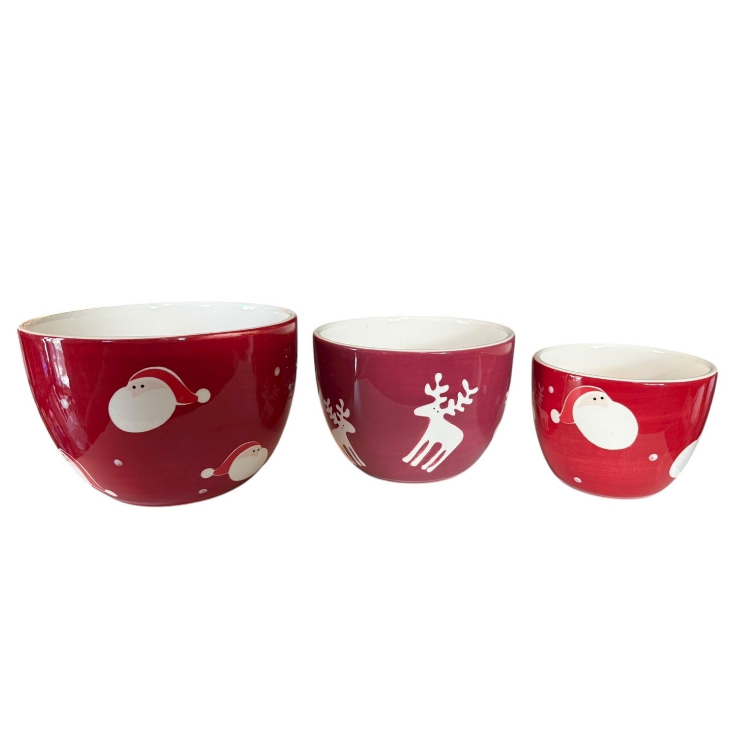 Three red bowls with white Christmas-themed designs on a white background