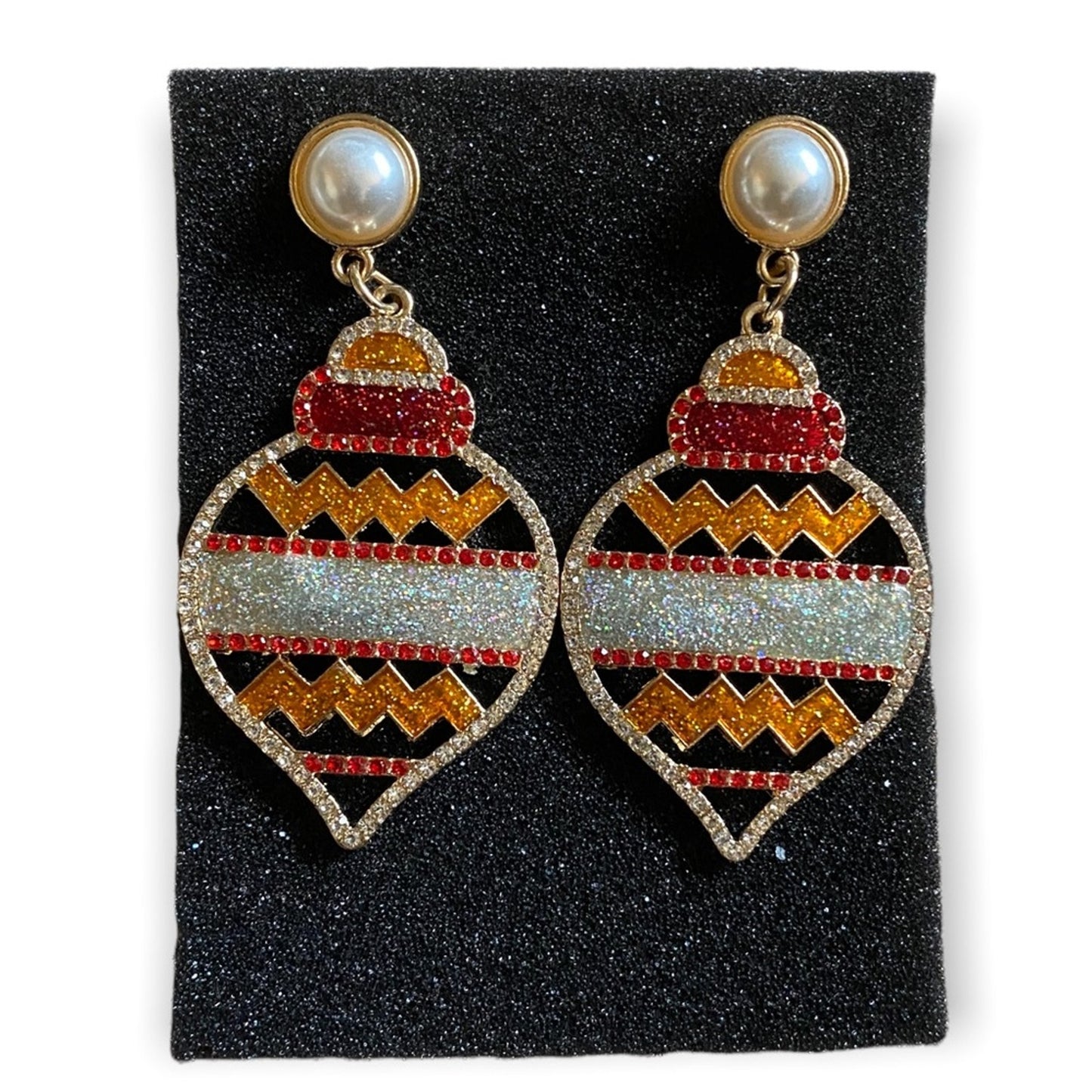Pair of earrings with holiday design on a black foam