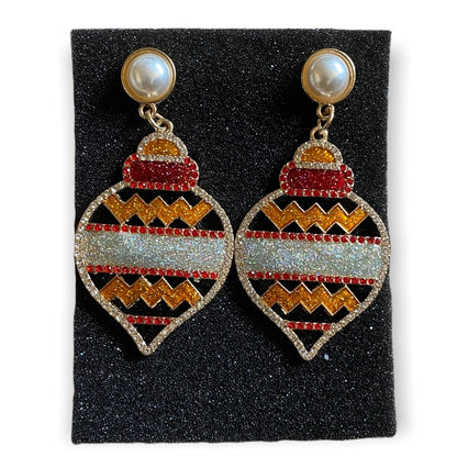 Pair of earrings with holiday design on a black foam