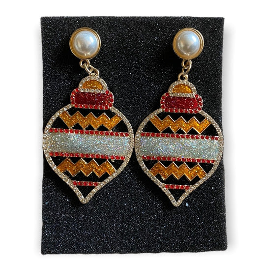 Pair of earrings with holiday design on a black foam