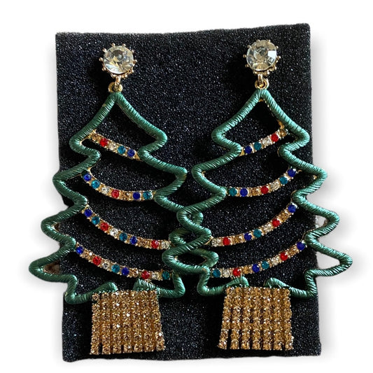 A pair of Christmas tree-shaped drop earrings with green wire outlines, multicolor rhinestone garlands, clear crystal studs, and gold dangling fringe, displayed on a black textured backing card against a white background.
